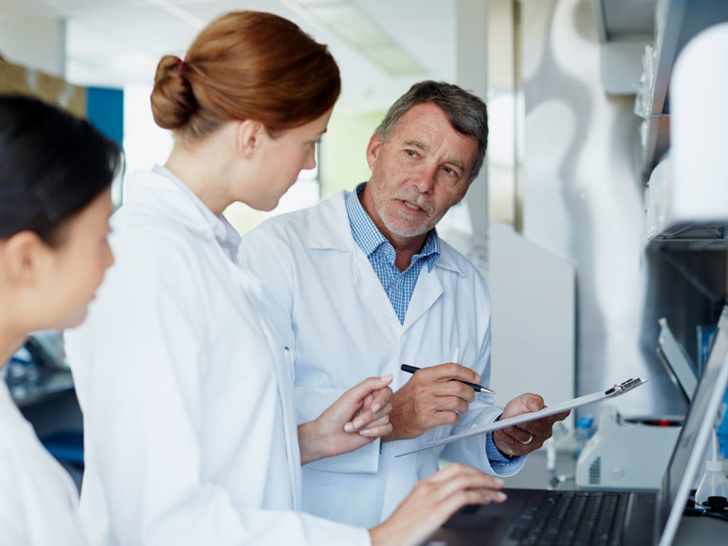 Photo of a medical research team discussing phototherapy.