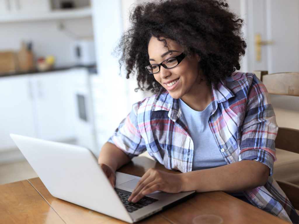 Photo of a patient doing research on a computer to see if uv phototherapy is a potential treatment for their condition.